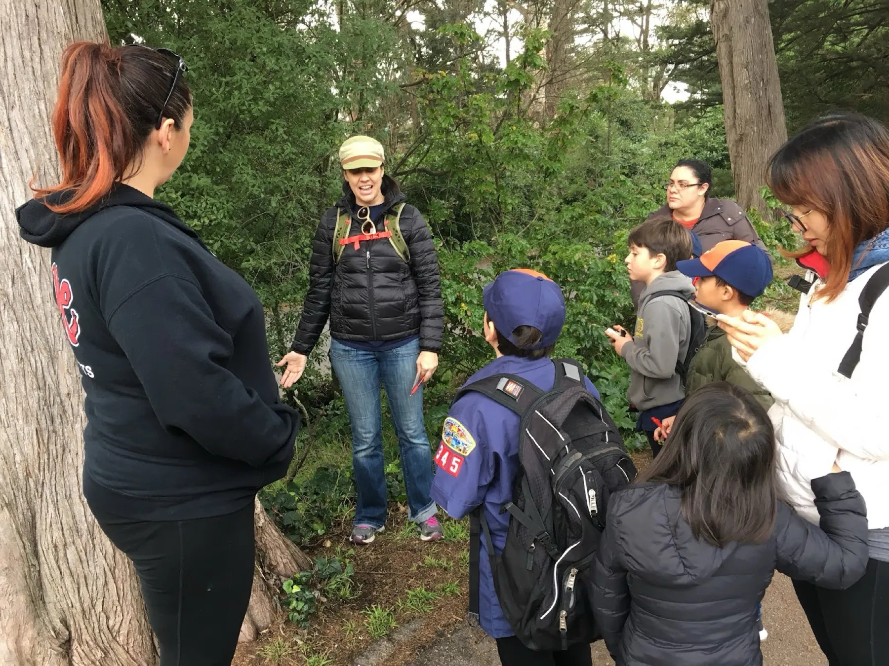A den leader working with scouts around a table